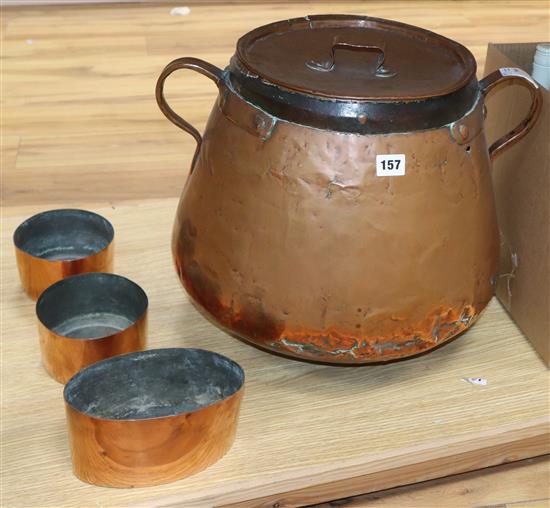 A Victorian copper pan and three smaller copper pans